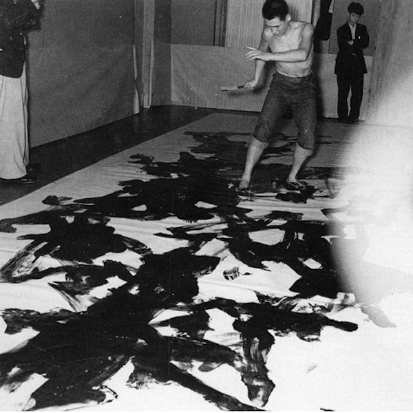 kazuo-shiraga-painting-at-the-2nd-gutai-art-exhibition-ohara-kaikan-tokyo-1956-1