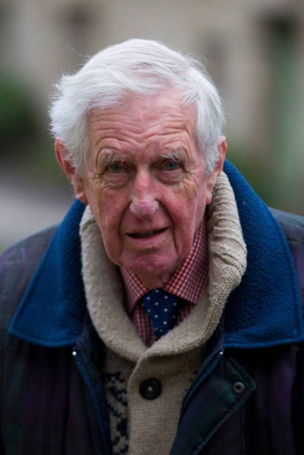 Peter Maddox, 82, stands next to his yellow Vauxhall Corsa at Arlington Row in Bibury, Cotswolds. The yellow car has been the cause of controversy for spoiling the view.See SWNS story SWYELLOW; A bright yellow car is photo-bombing England's most picturesque view. Tourists' picture-postcard shot of the Cotswold's Arlington Row are being ruined by "ugly" car - which is appearing in photographs all over the world. The 14th century cottages, owned by the National Trust, are the most photographed cottages in Britain and attract swarms of visitors every year. The car's owner, Peter Maddox, 82, said there was nothing he could do about the banana yellow car.