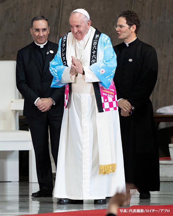 Pope Francis receives a traditional Japanese shirt designed by Catholic youths at St. Mary's Cathedral in Tokyo, Japan, November 25, 2019. Pierre Emmanuel Deletree/Pool via REUTERS