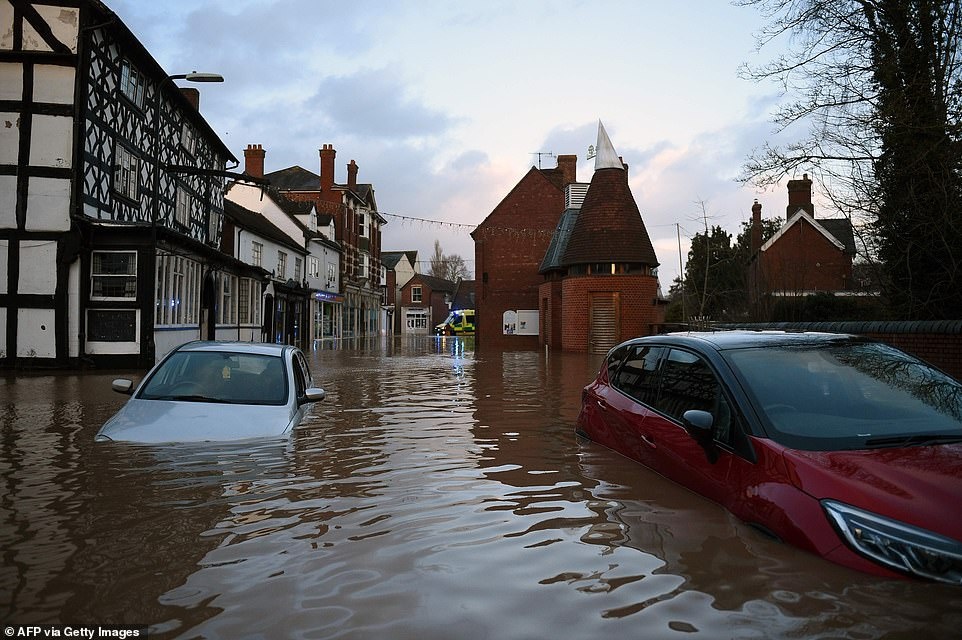 24809790-8010579-Flood_water_surrounded_two_abandoned_cars_that_had_been_left_in_-a-312_1581891127313.jpg