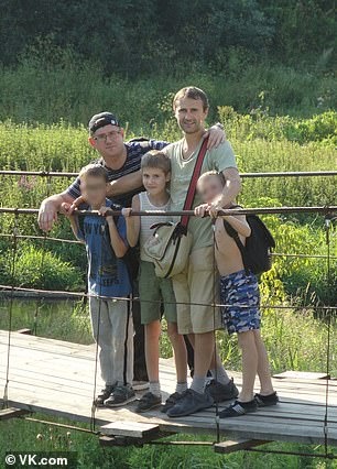 24384210-7973281-Oleg_Drachev_second_from_the_right_with_his_son_Ilya_third_from_-a-55_1580982739091.jpg