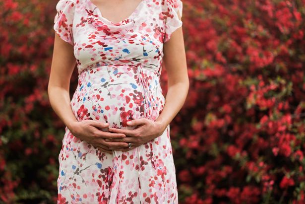 0_Pregnant-Caucasian-woman-holding-her-belly-outdoors.jpg